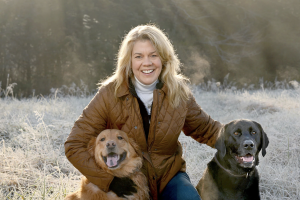 Sarah Parker Pauley headshot outdoors with dogs
