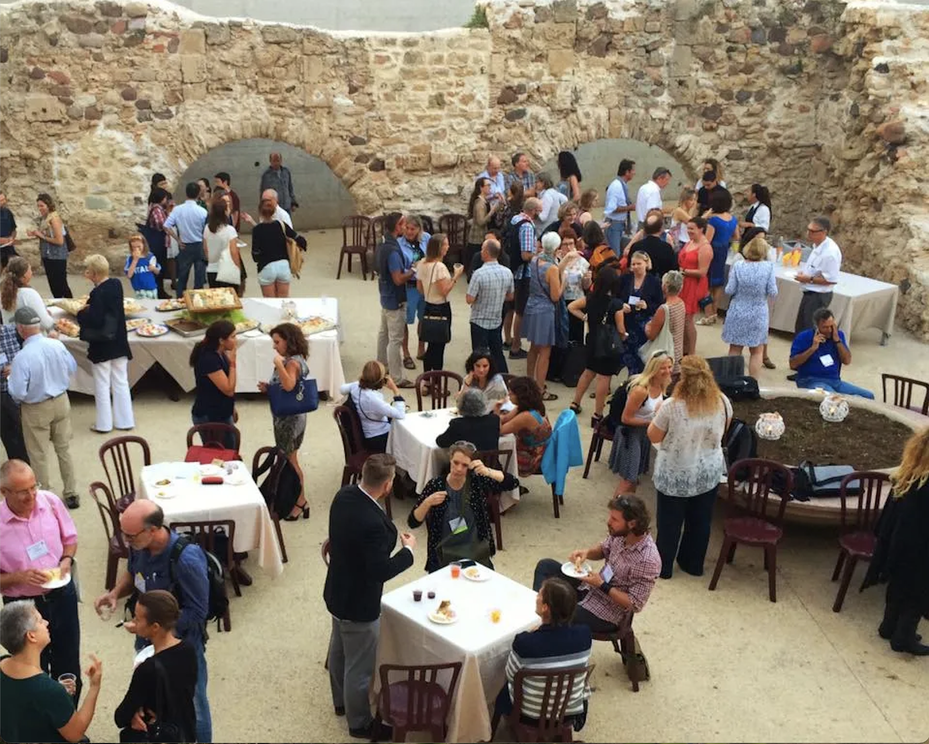 Conference attendees enjoying a meal together in Alghero, Italy